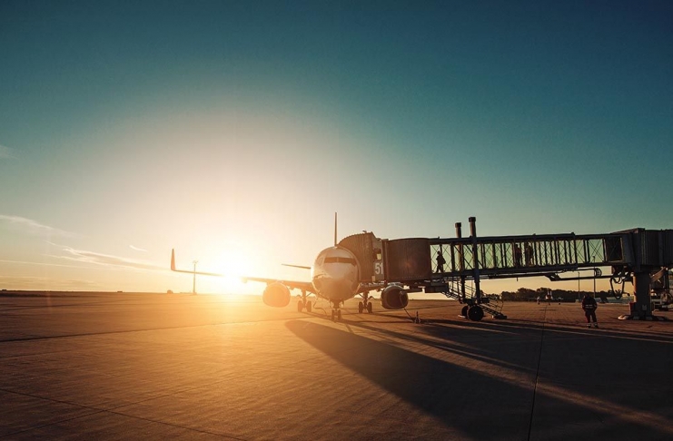 Airplane in airport runway during sunset