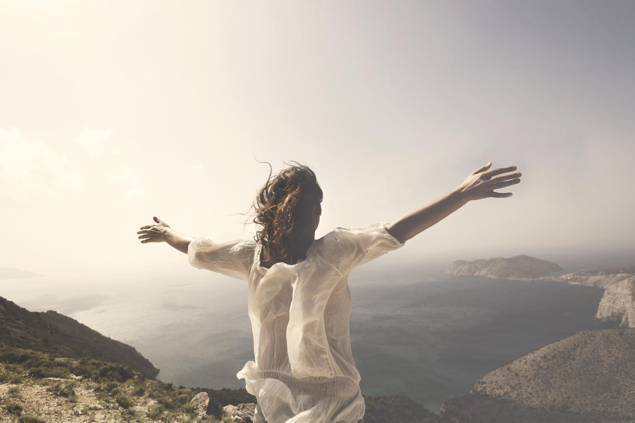woman taking a breath in front of a spectacular view