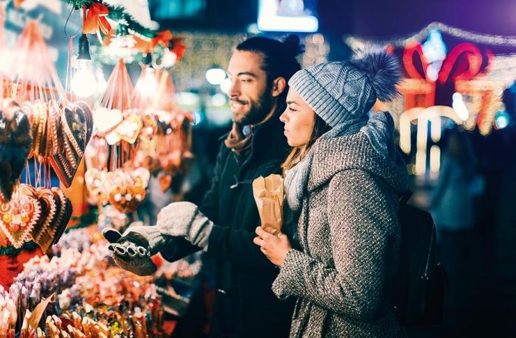 Young Couple Having Fun Outdoors At Christmas Time