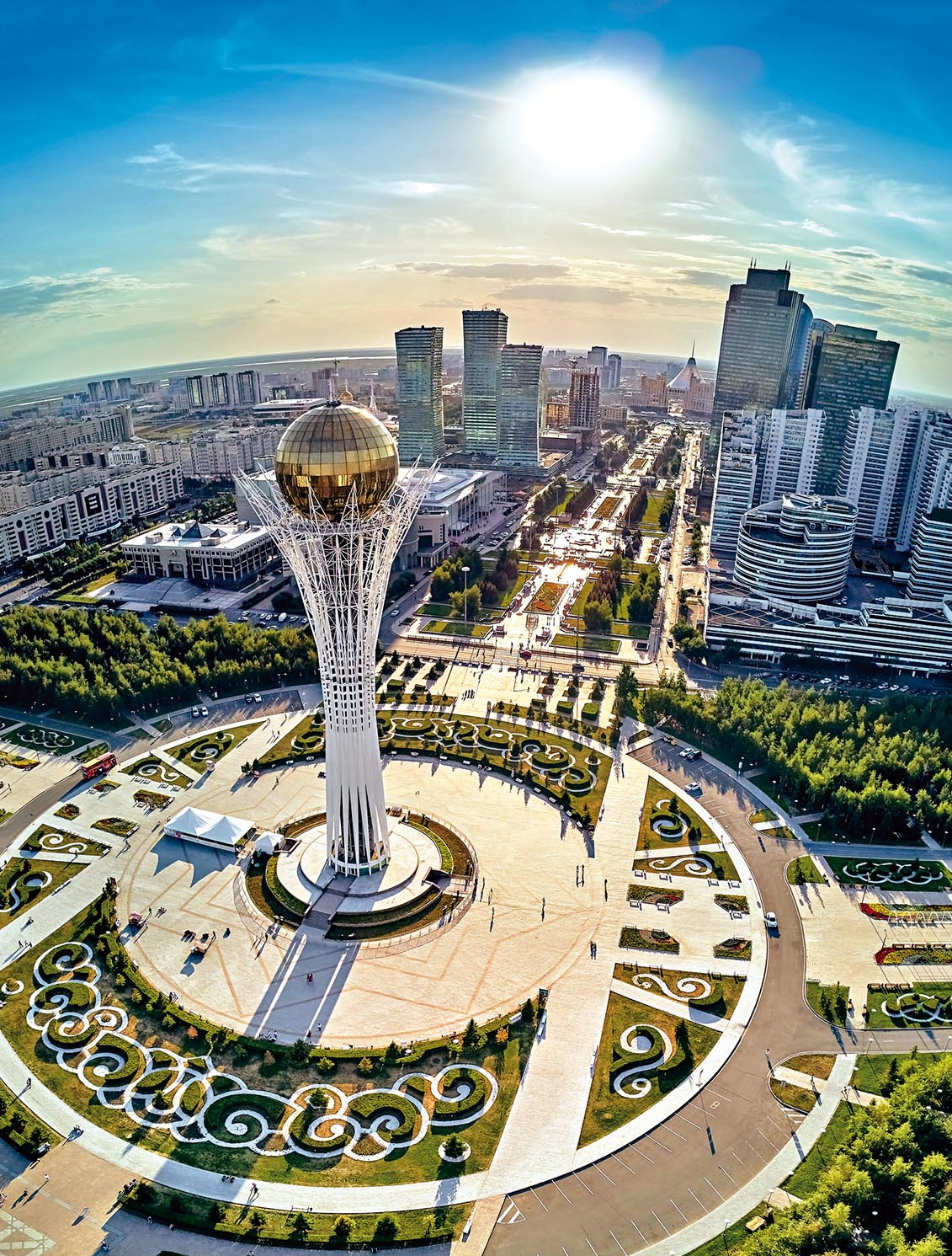 Beautiful panoramic aerial drone night illumination view to Astana city center with skyscrapers and Baiterek Tower, symbol Kazakh’s people freedom