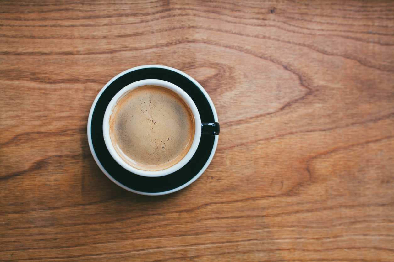 Coffee cup on the wooden desk concept