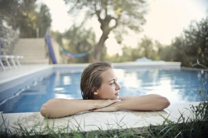 relaxed-woman-resting-at-poolside-in-summer-3771086